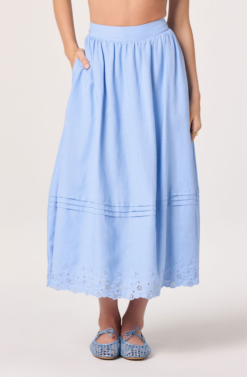 Light blue, ankle-length skirt with pleats, eyelet embroidery, and scalloped hem.