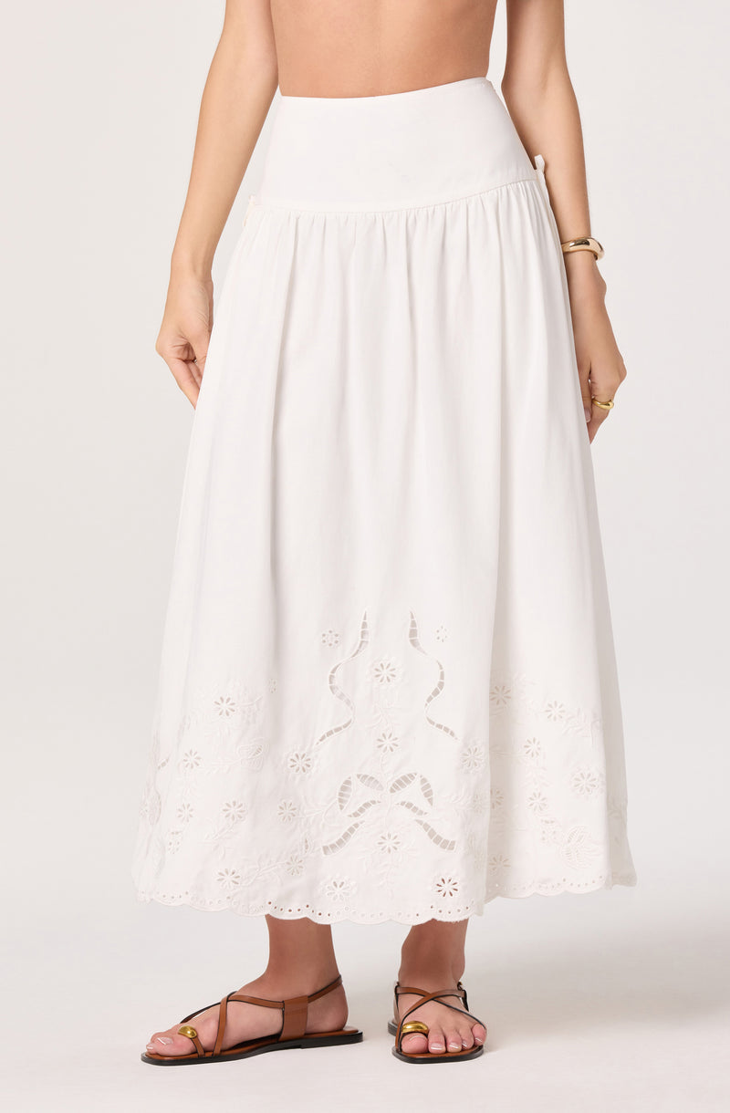 White high-waisted, ankle-length skirt with embroidered floral and snake patterns.