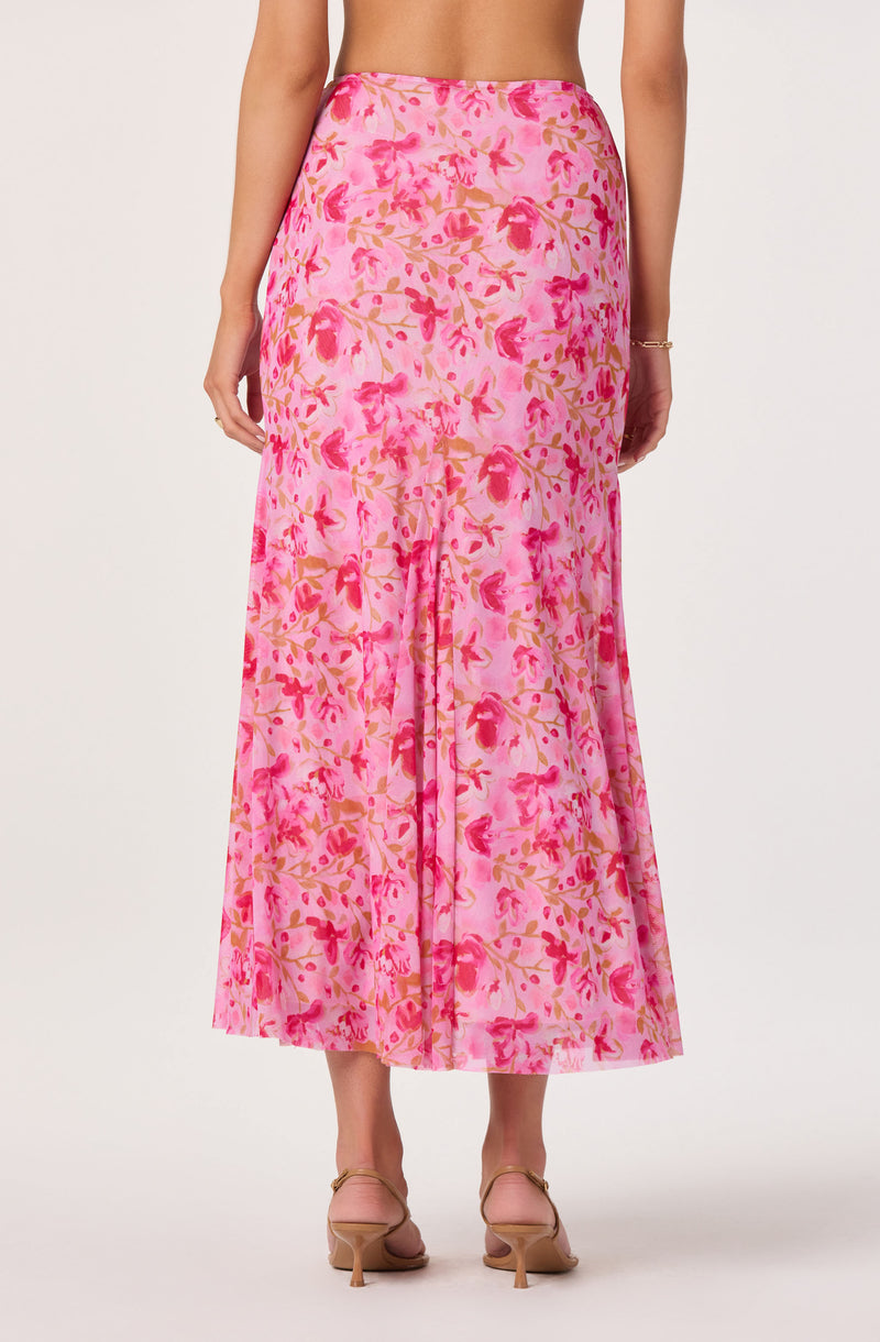 Long pink floral skirt with beige and reddish flower pattern, high waist, and flowy fabric.
