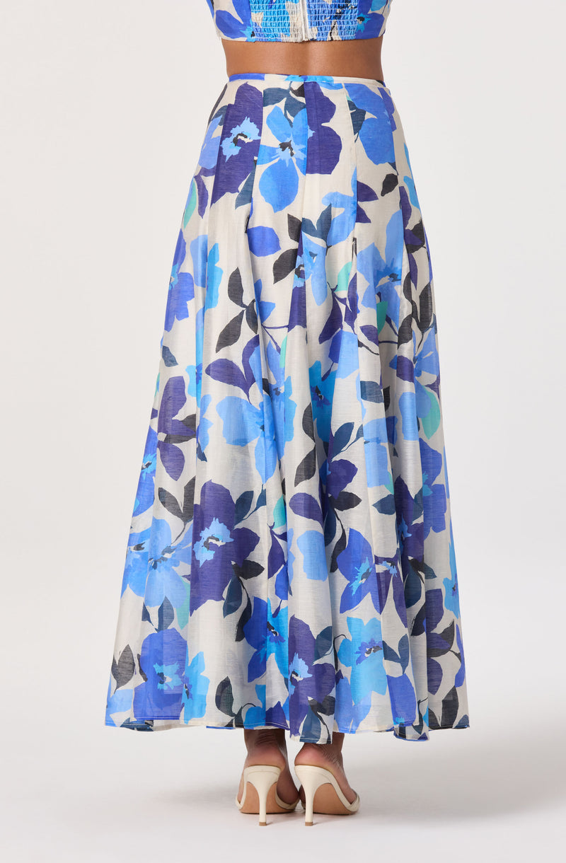 Long floral skirt with large blue, purple, and black flowers on a white background.