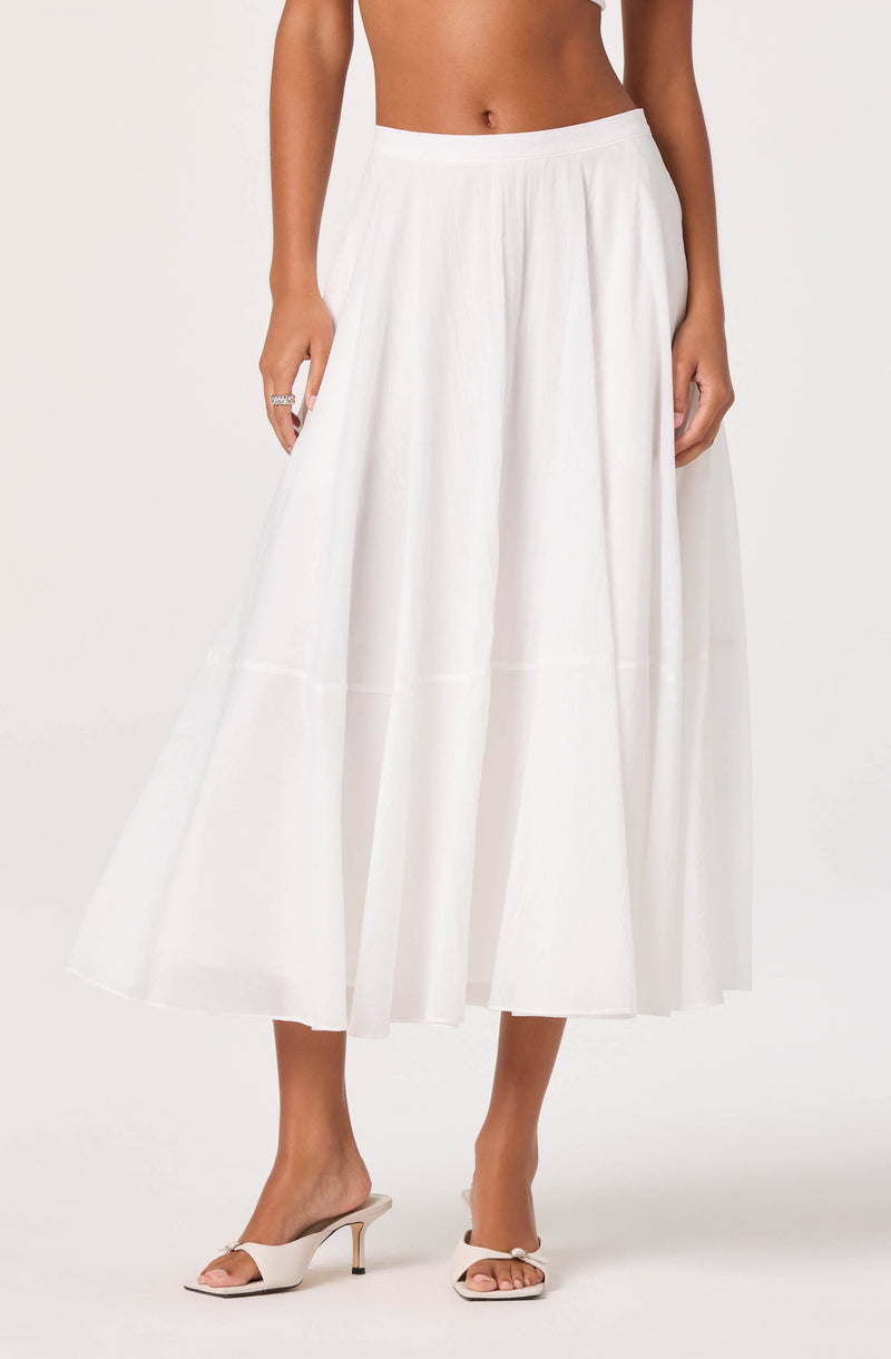 White wide-leg midi skirt with a tulle overlay, paired with open-toe heels.