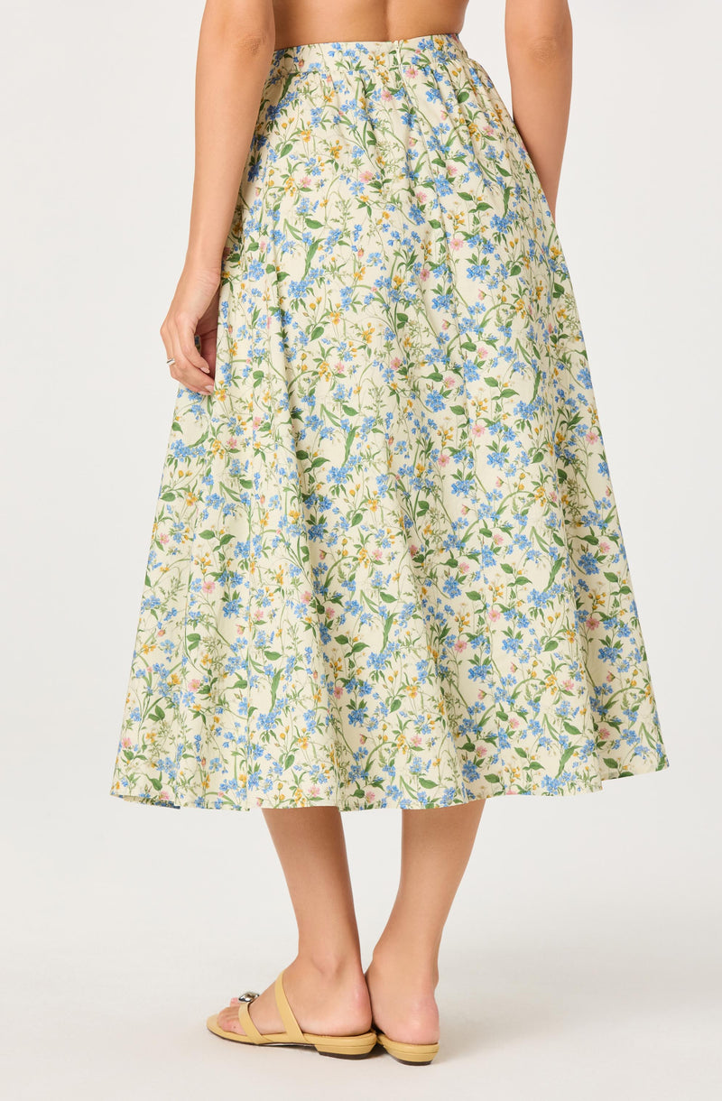 Women wearing a floral print, cream-colored, ankle-length skirt with a gathered waist.