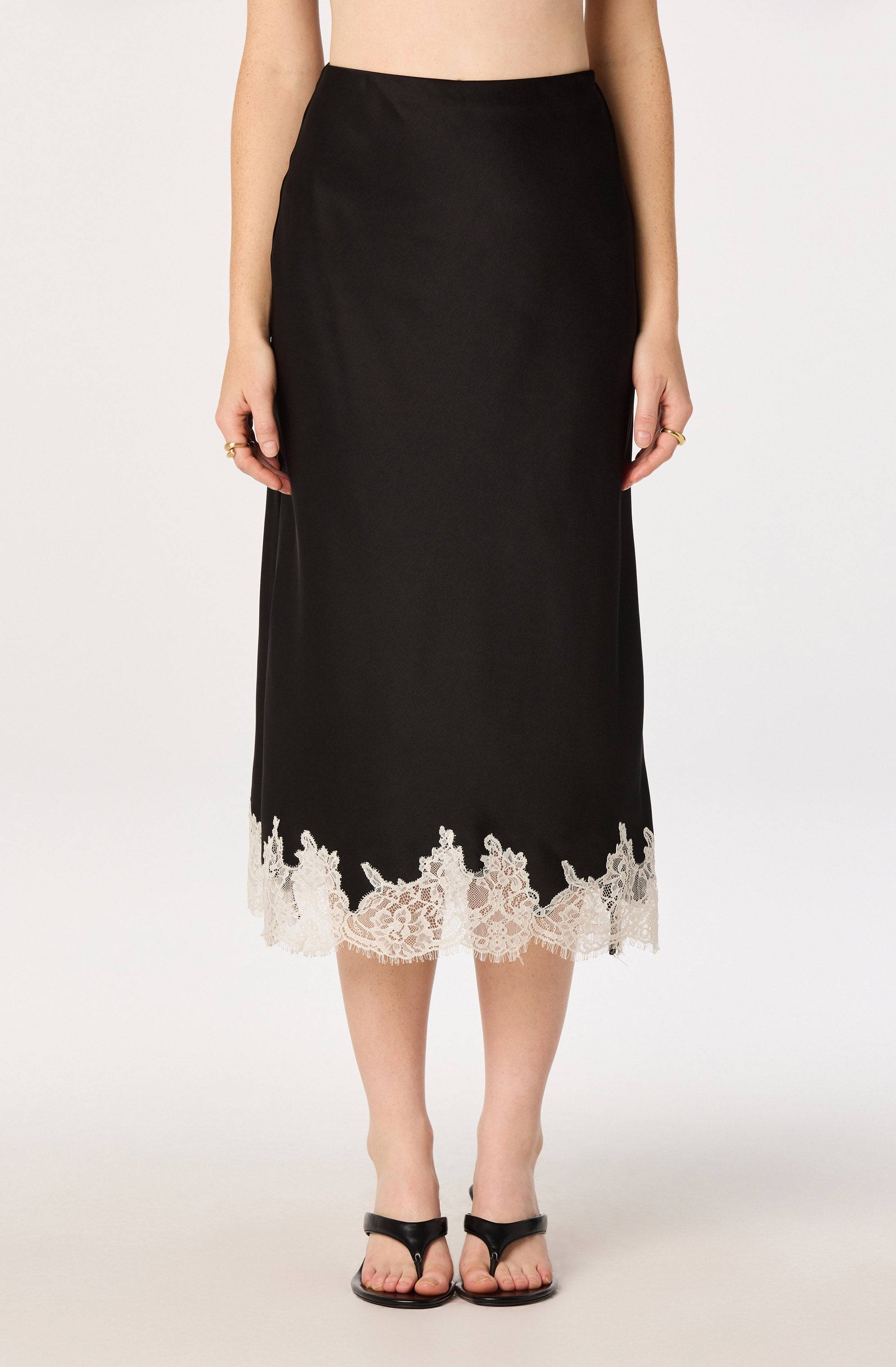Black midi skirt with white lace hem.