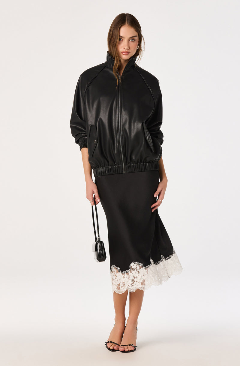Black leather bomber jacket with elastic cuffs, and a black skirt with white lace hem.