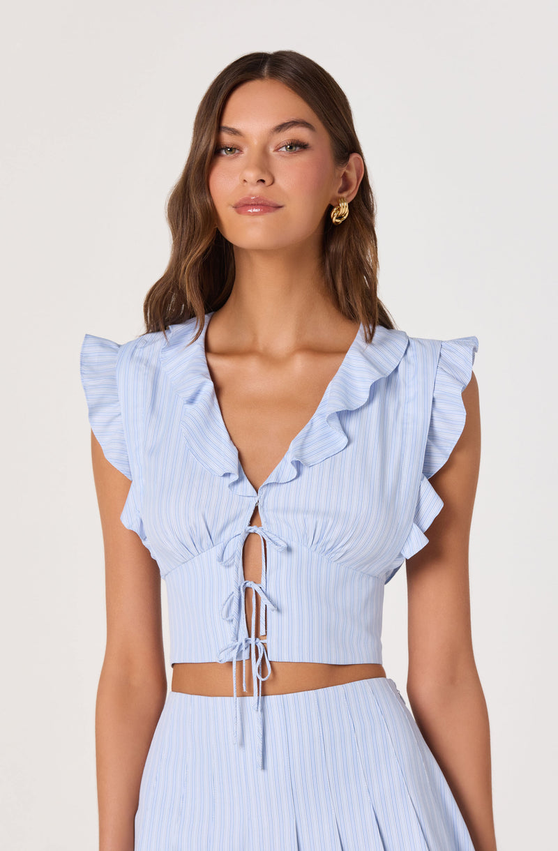 Light blue sleeveless top with ruffled shoulders and front ties, paired with matching striped skirt.