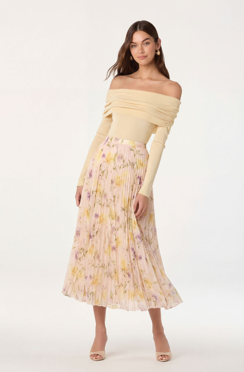 Off-the-shoulder cream top with ruching details and a pleated, floral midi skirt in pastel colors.