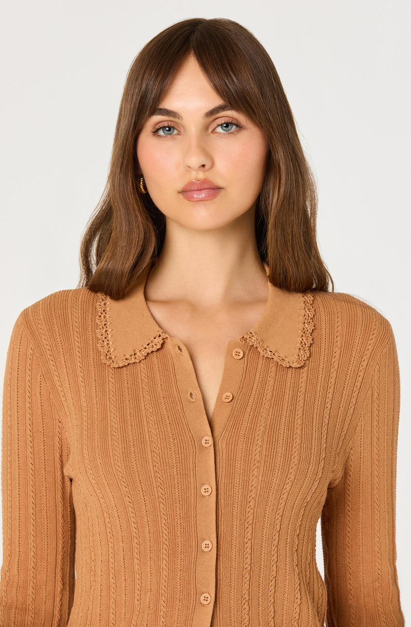 Woman in a caramel-colored button-up sweater with a lace-edged collar.
