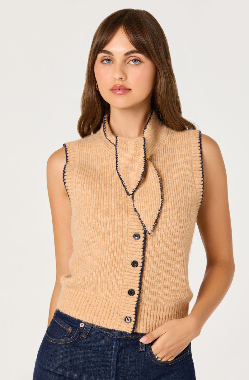 Beige sleeveless knit vest with dark trim and black buttons.
