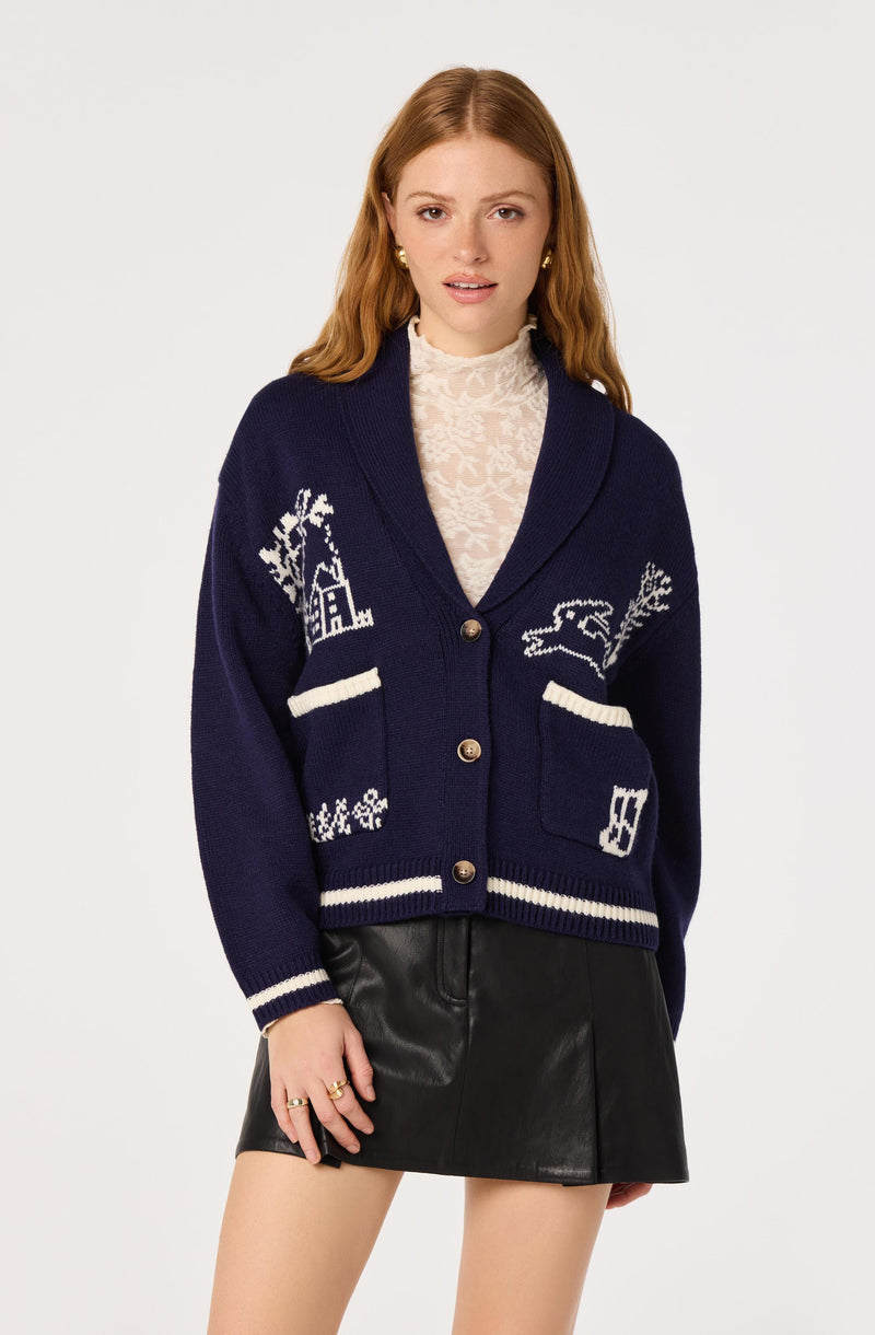 Young woman wearing a navy blue cardigan with white patches and a leather mini skirt.