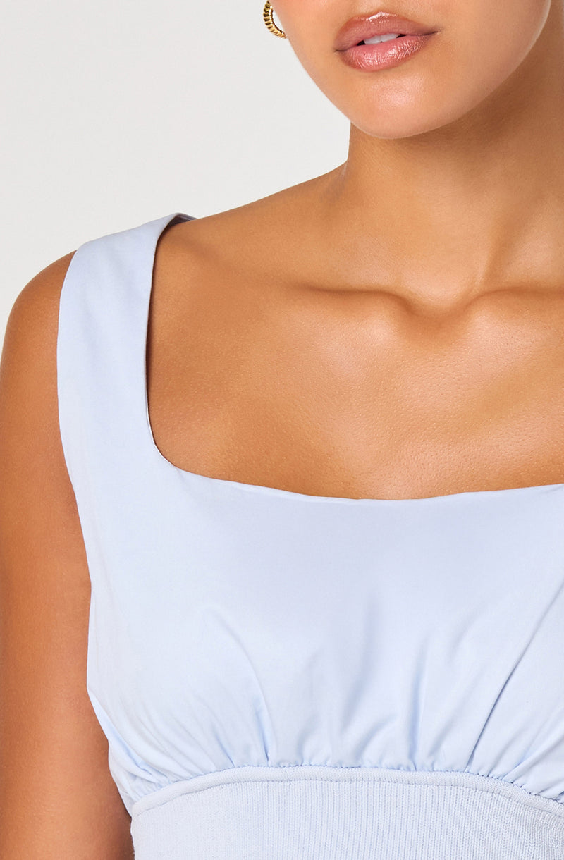 Light blue sleeveless dress with a square neckline and gathered waist.