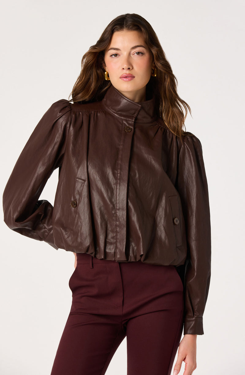 Brown leather jacket with puffed shoulders and a high collar, paired with burgundy pants.