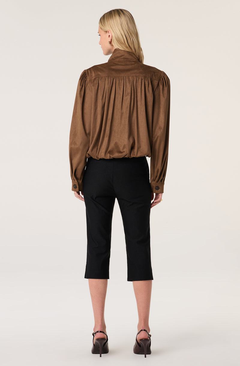 Brown long-sleeve, faux suede blouse with puffed sleeves and buttoned cuffs.