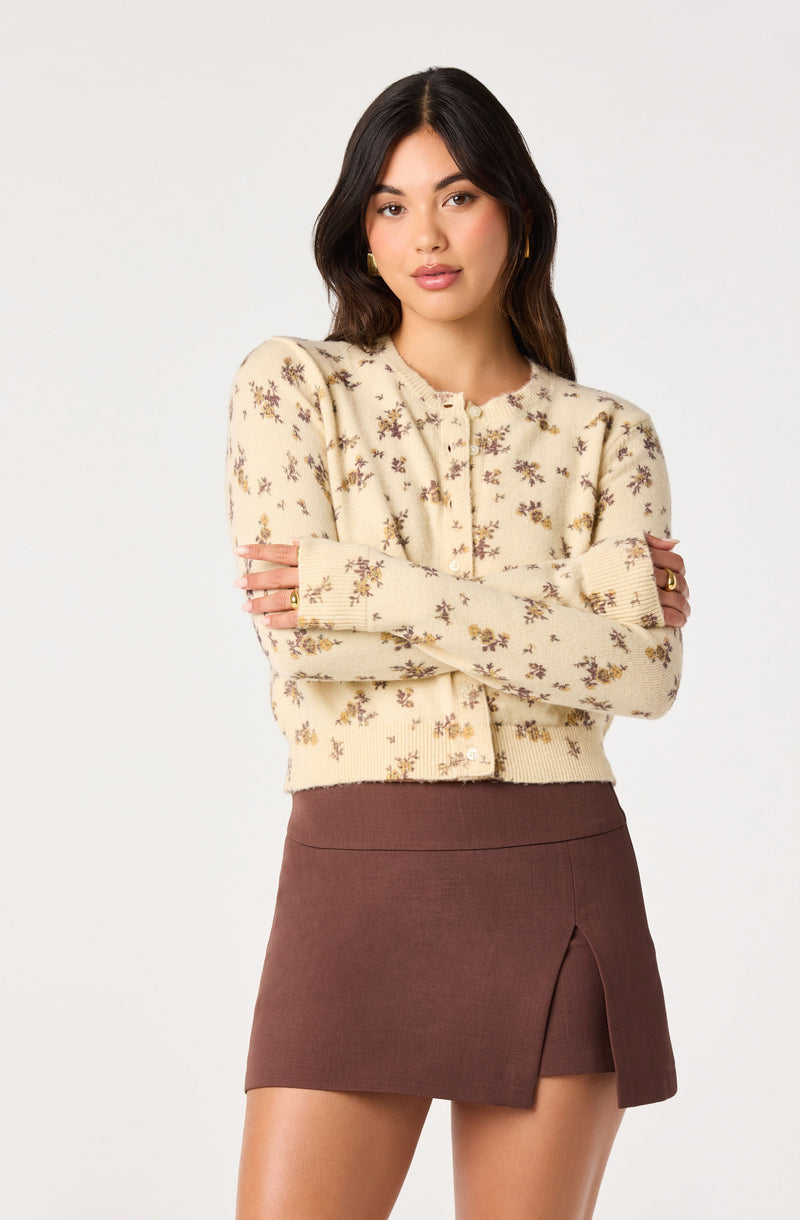 Cream floral patterned knit cardigan, high-waisted brown skirt with side slit.