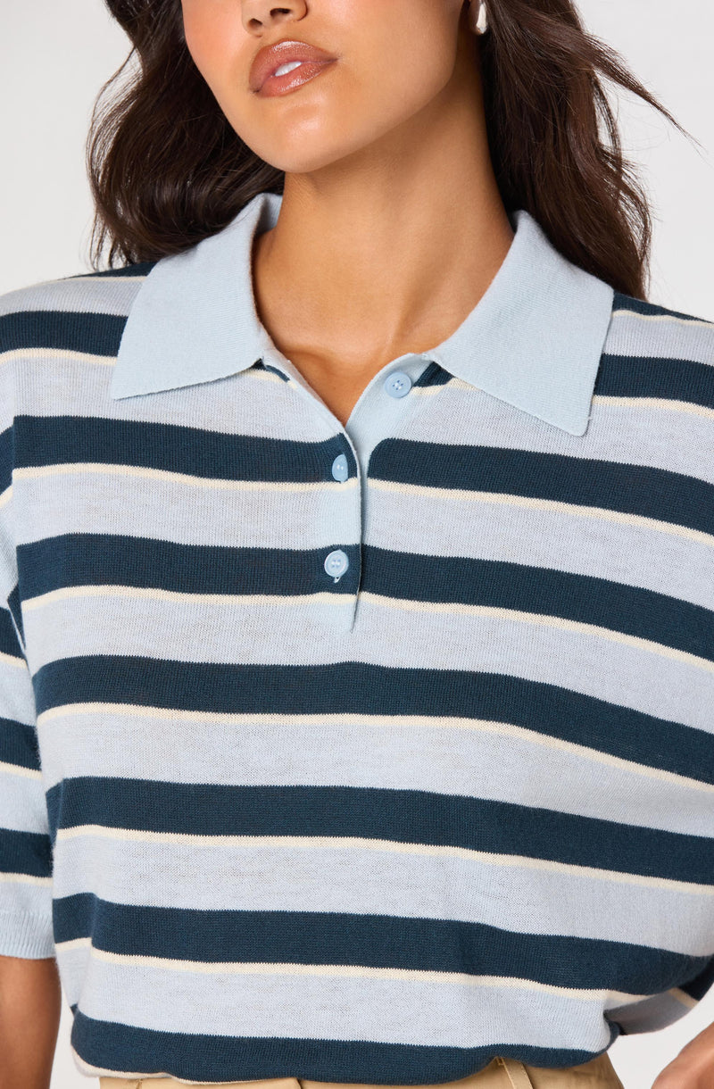 Women’s striped polo shirt with light blue collar and buttons.