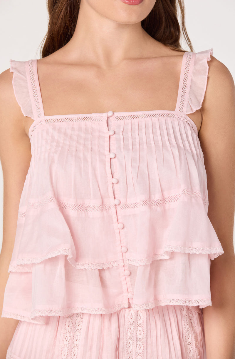 Pink sleeveless top with ruffled shoulder straps and vertical pleats, button front, and tiered ruffle layers.