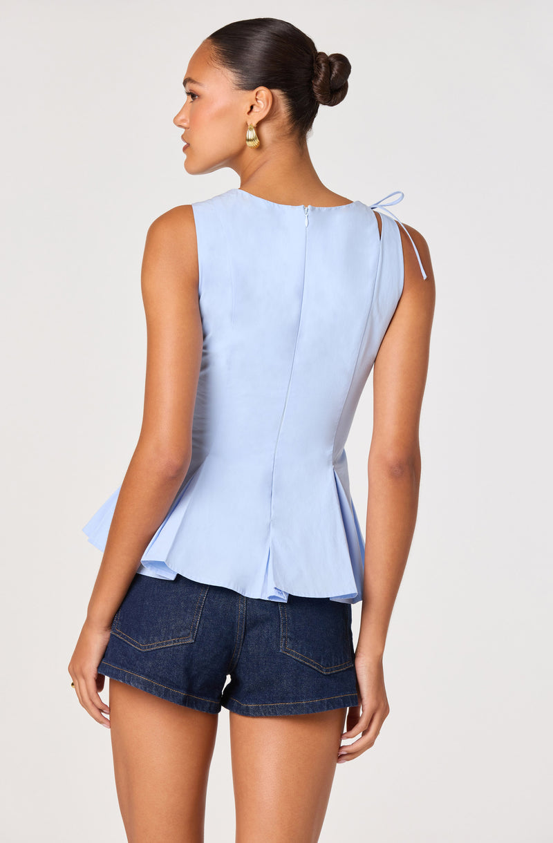 Light blue sleeveless top with a side zipper and tied shoulder strap.