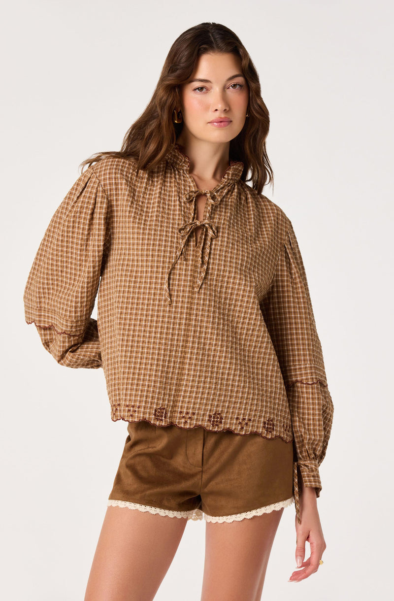 Brown checkered blouse with puffed long sleeves and a front tie collar.