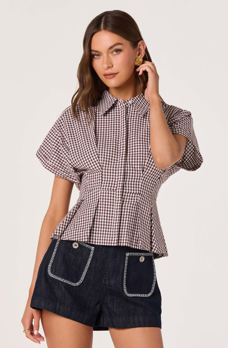 Gingham short-sleeve blouse with a fitted waist and dark denim shorts with pocket details.