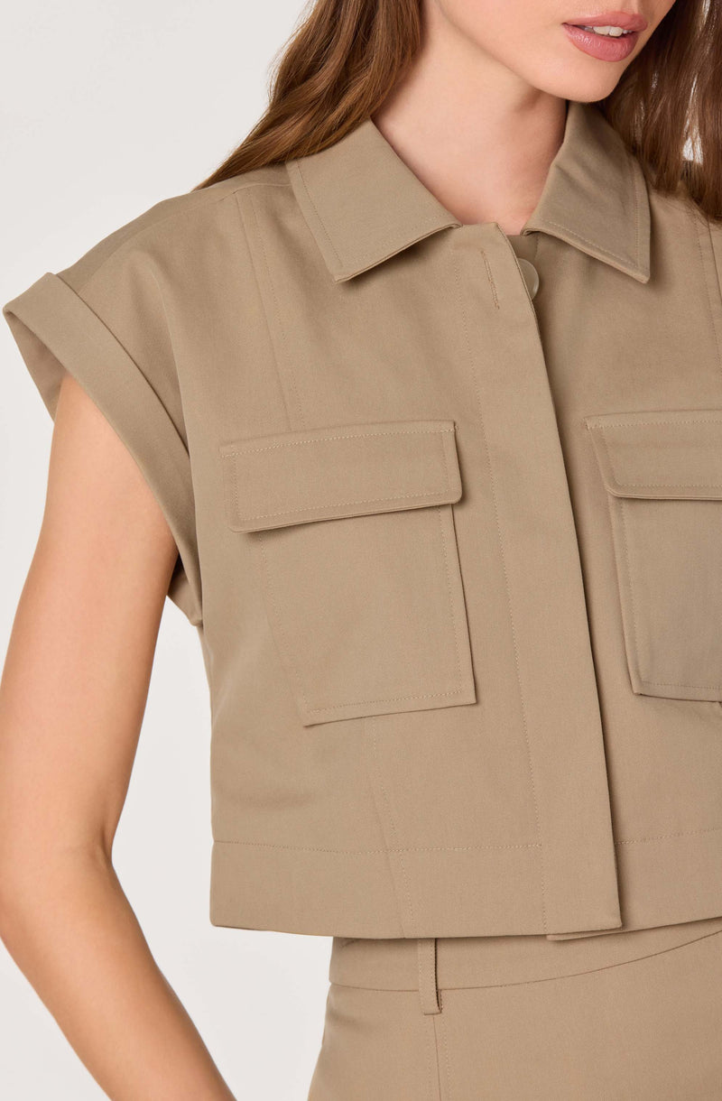 Beige short-sleeve button-up shirt with flap chest pockets and a collar.