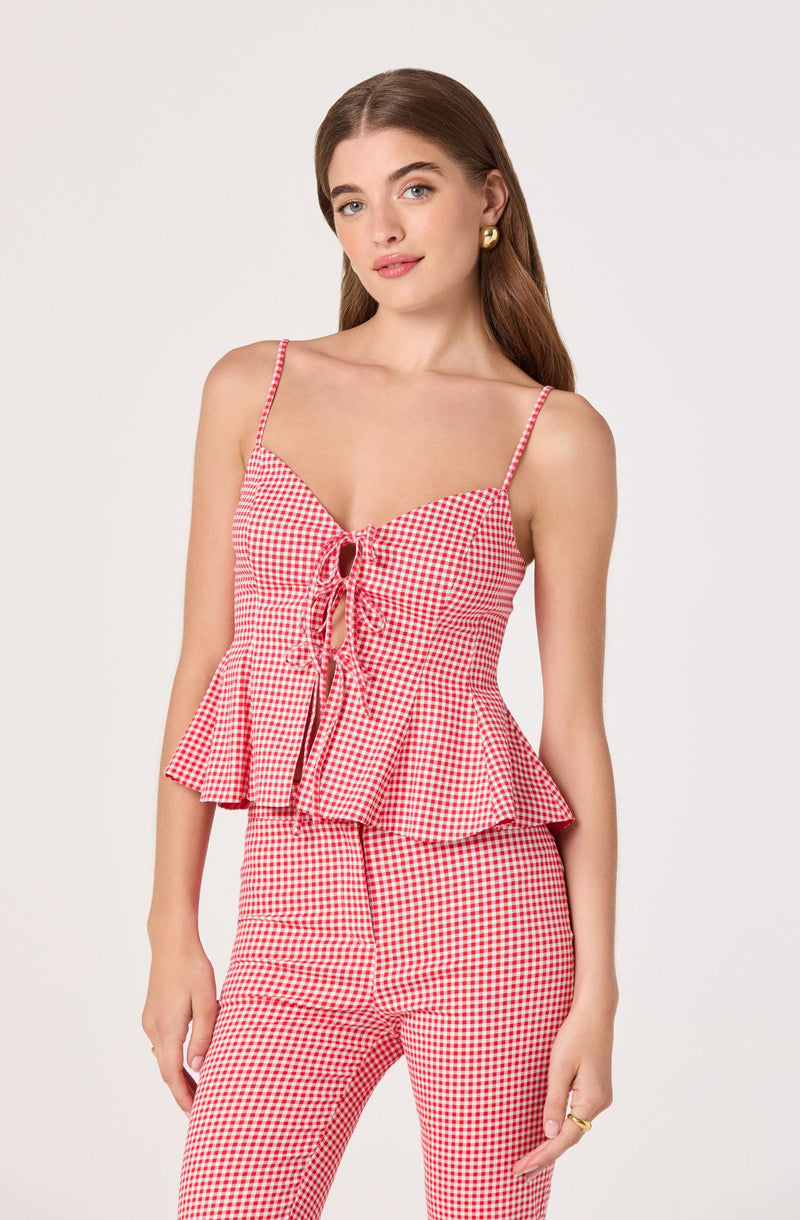 Girl in red and white gingham tank top with spaghetti straps and tie-front design, matching pants.
