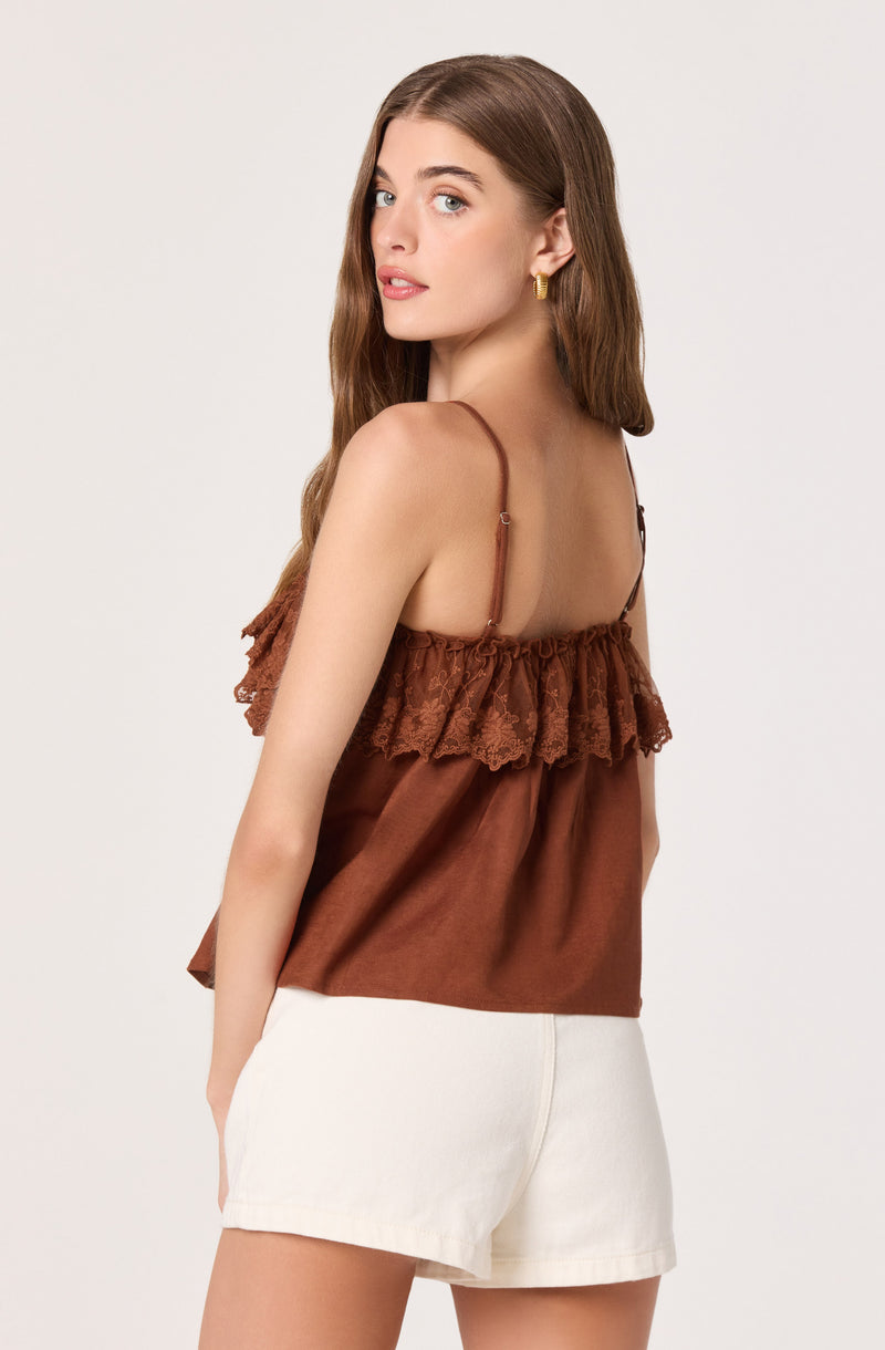 Brown spaghetti strap top with lace ruffle detail. White shorts.