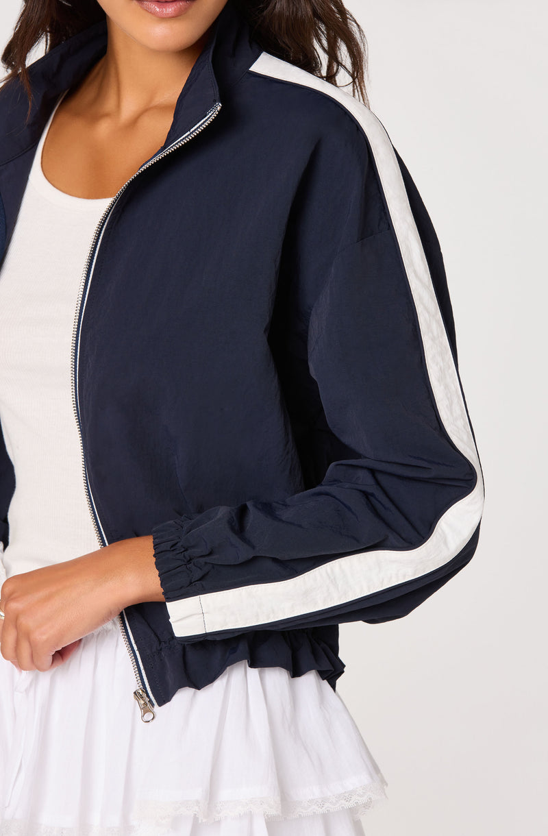 Navy and white windbreaker with white stripe details on sleeves and shoulders.