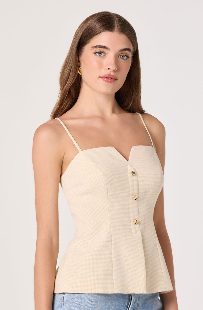 Beige sleeveless top with thin straps and gold buttons, fitted at the waist.