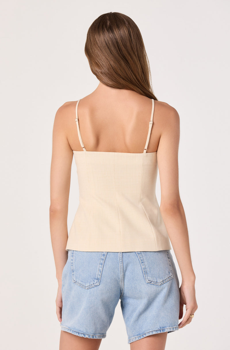 Beige spaghetti strap top paired with light blue denim shorts.