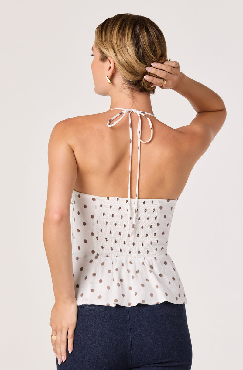 White halter top with brown polka dots and a ruffled hem.