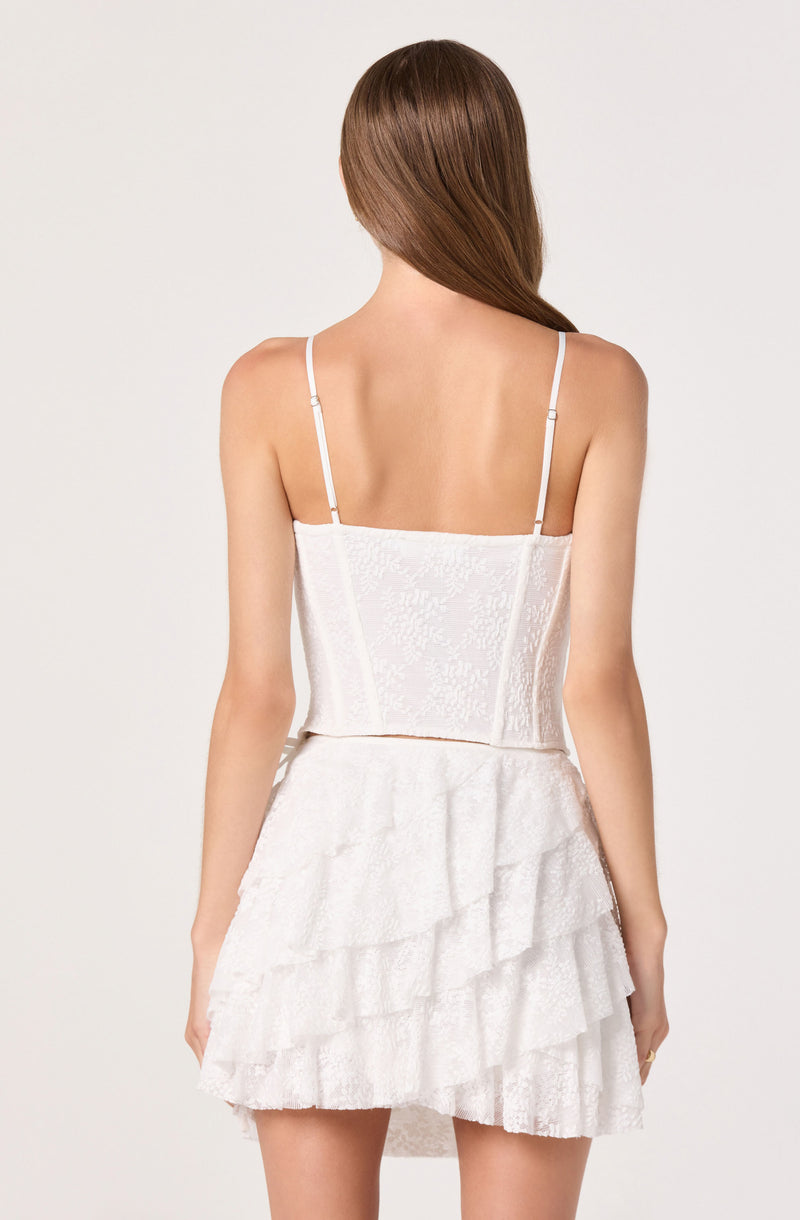 White sleeveless dress with adjustable spaghetti straps and layered ruffled skirt.