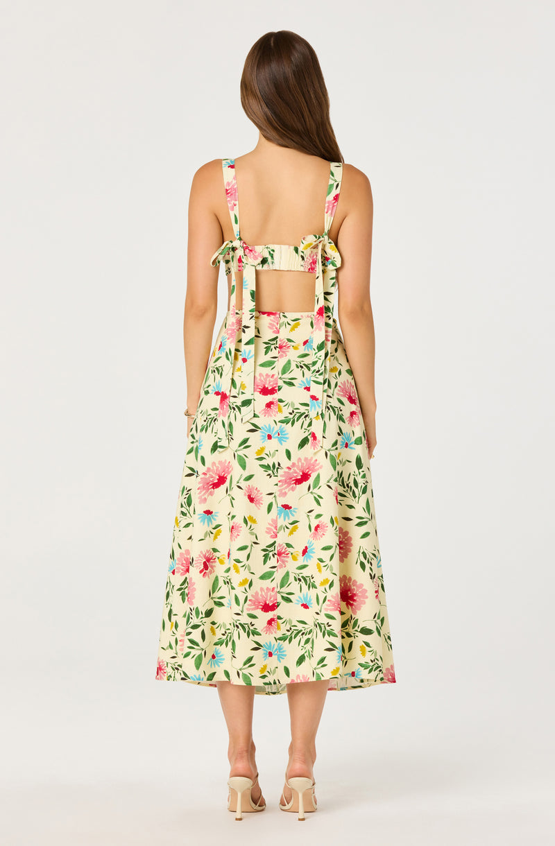 Cream dress with pink, red, blue, and green floral pattern, sleeveless with tied shoulder straps.