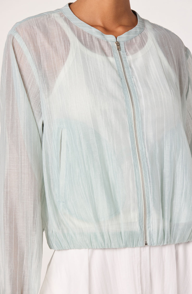 Light pastel blue lightweight zip-up jacket with sheer vertical stripes and a round collar.
