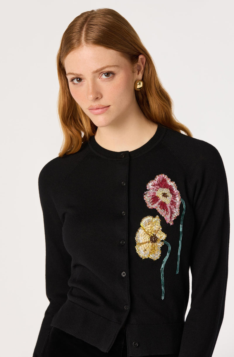 Black cardigan with embroidered pink and yellow flowers.
