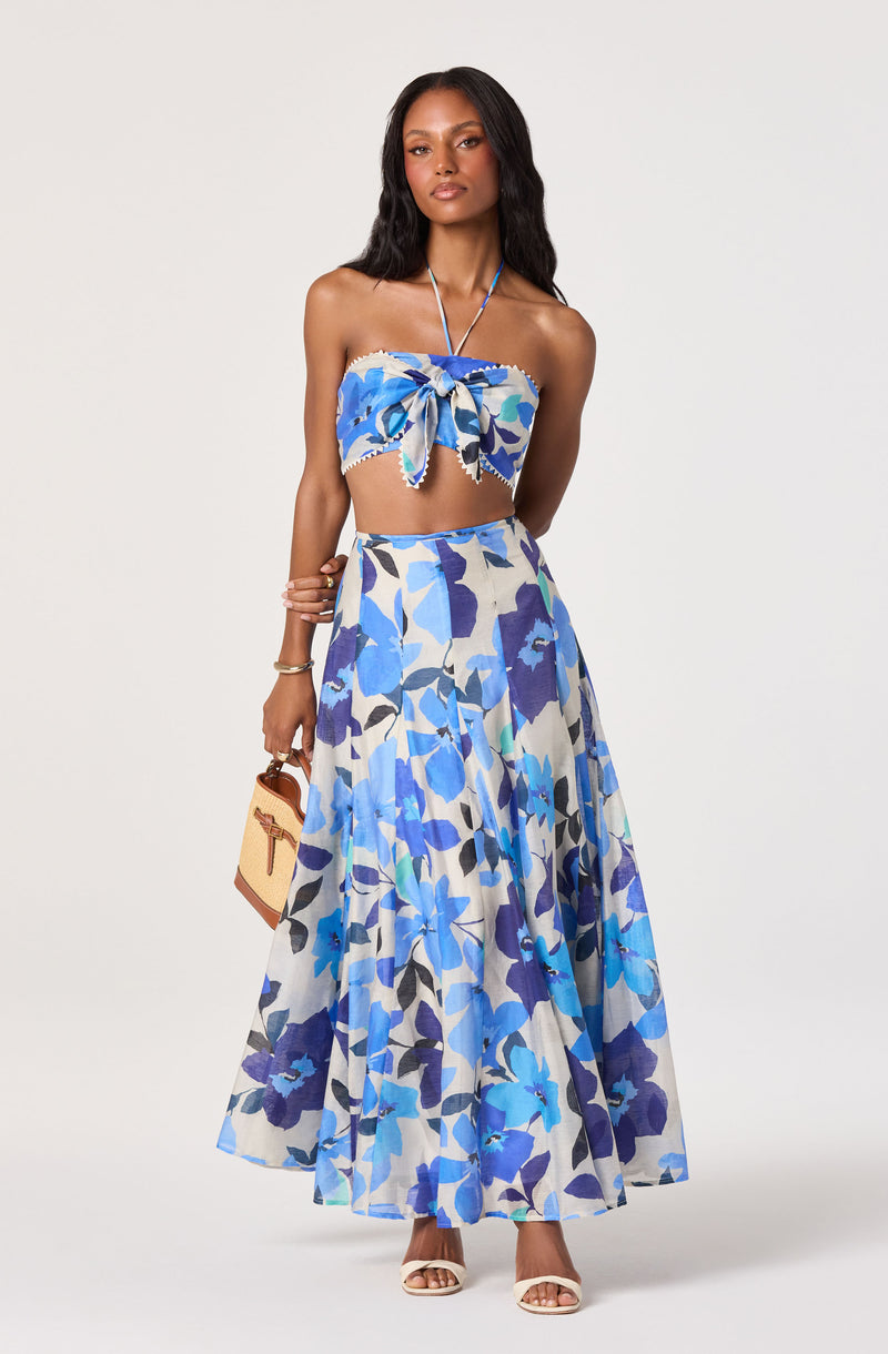 Blue and white floral strapless crop top with bow detail, matching long flowy skirt.