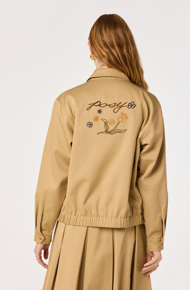 Beige jacket with embroidered flower design and "posy" text on back, paired with a matching beige skirt.