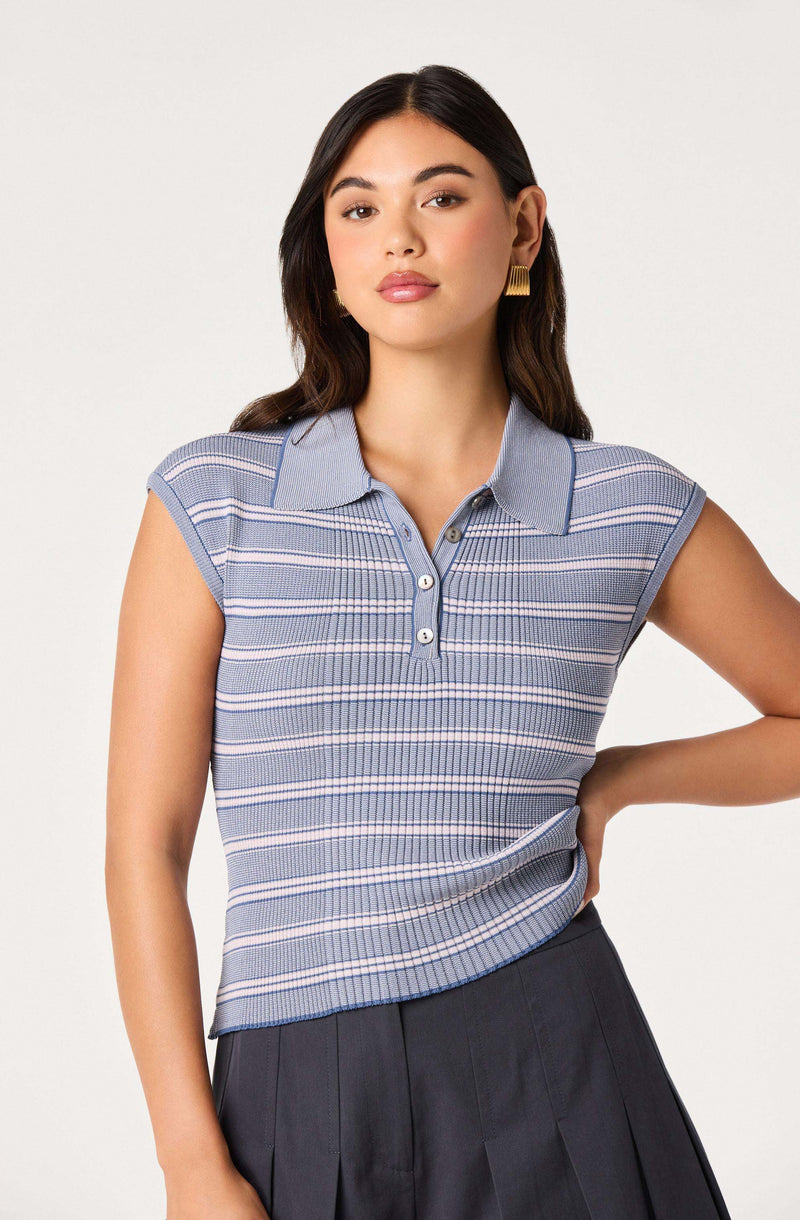 Woman wearing a blue, striped, sleeveless polo shirt with a collar and button placket.