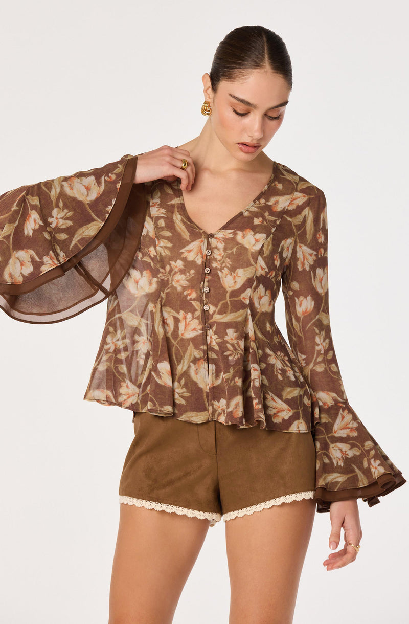 Sheer brown floral blouse with bell sleeves and button details, paired with brown shorts with lace trim.