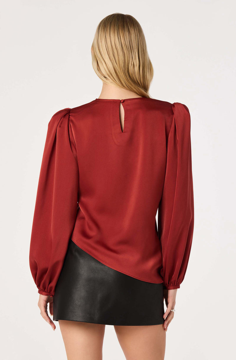 Red satin blouse with puffed sleeves and a small keyhole opening at the back.