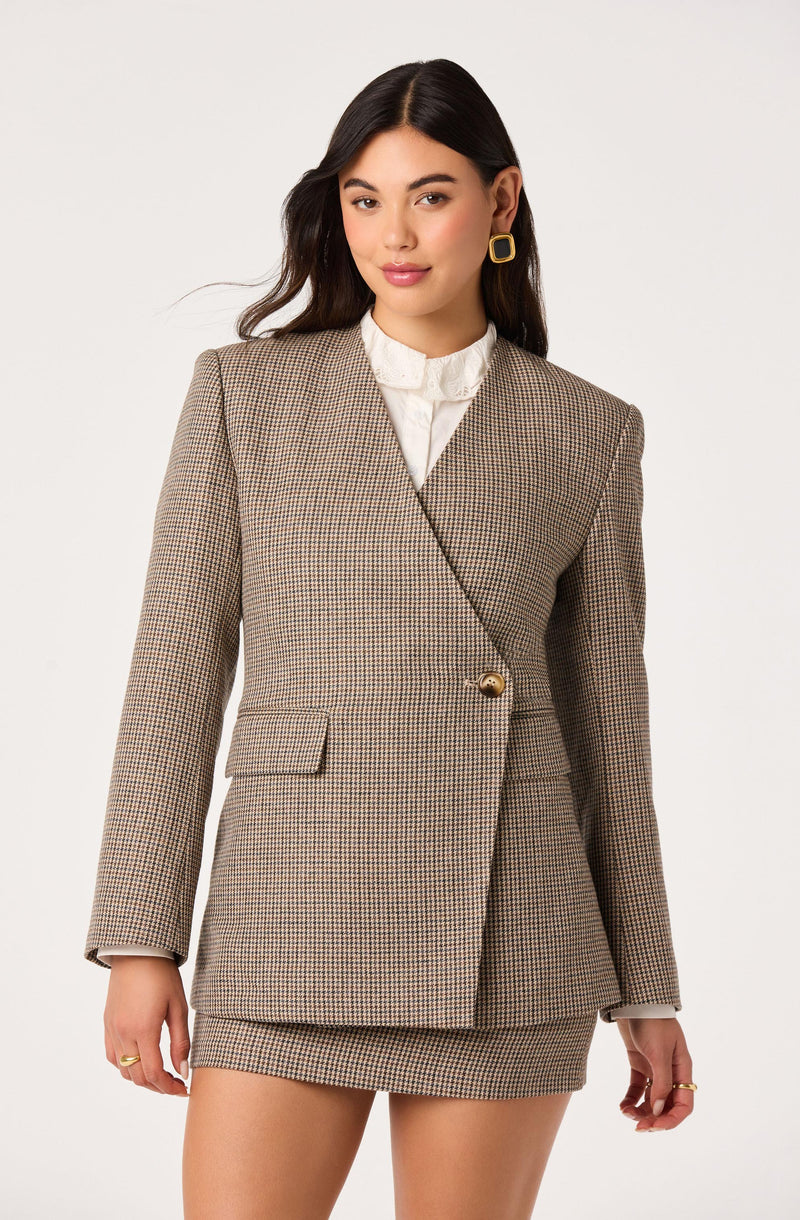 Woman wearing a beige and brown checkered blazer with a matching mini skirt.