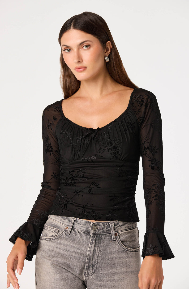 Black sheer blouse with floral embroidery and ruffled sleeve cuffs.