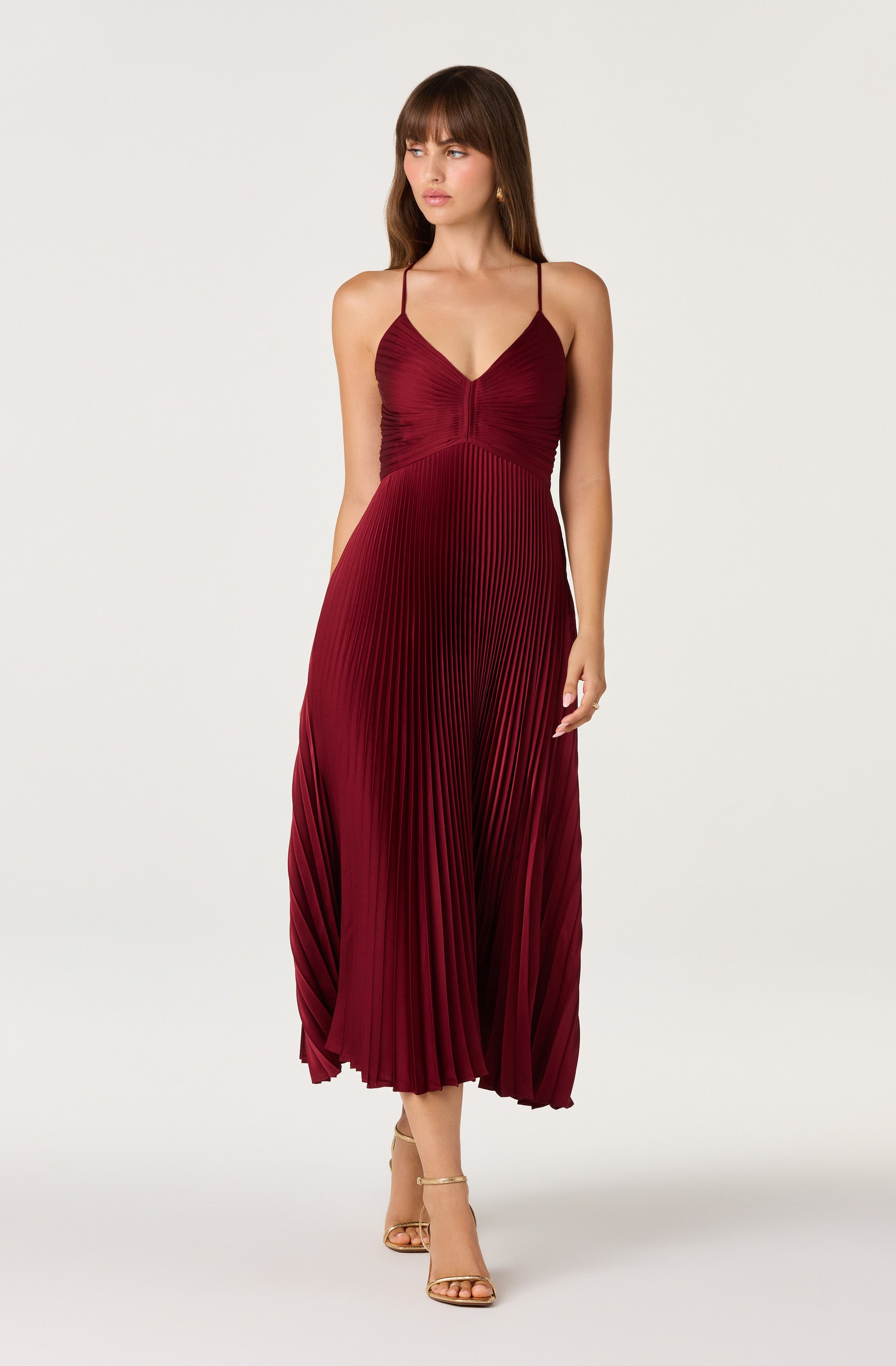 Red pleated midi dress with spaghetti straps and a fitted bodice.