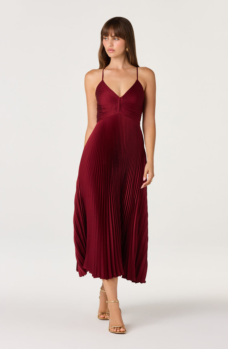 Red pleated midi dress with spaghetti straps and a fitted bodice.