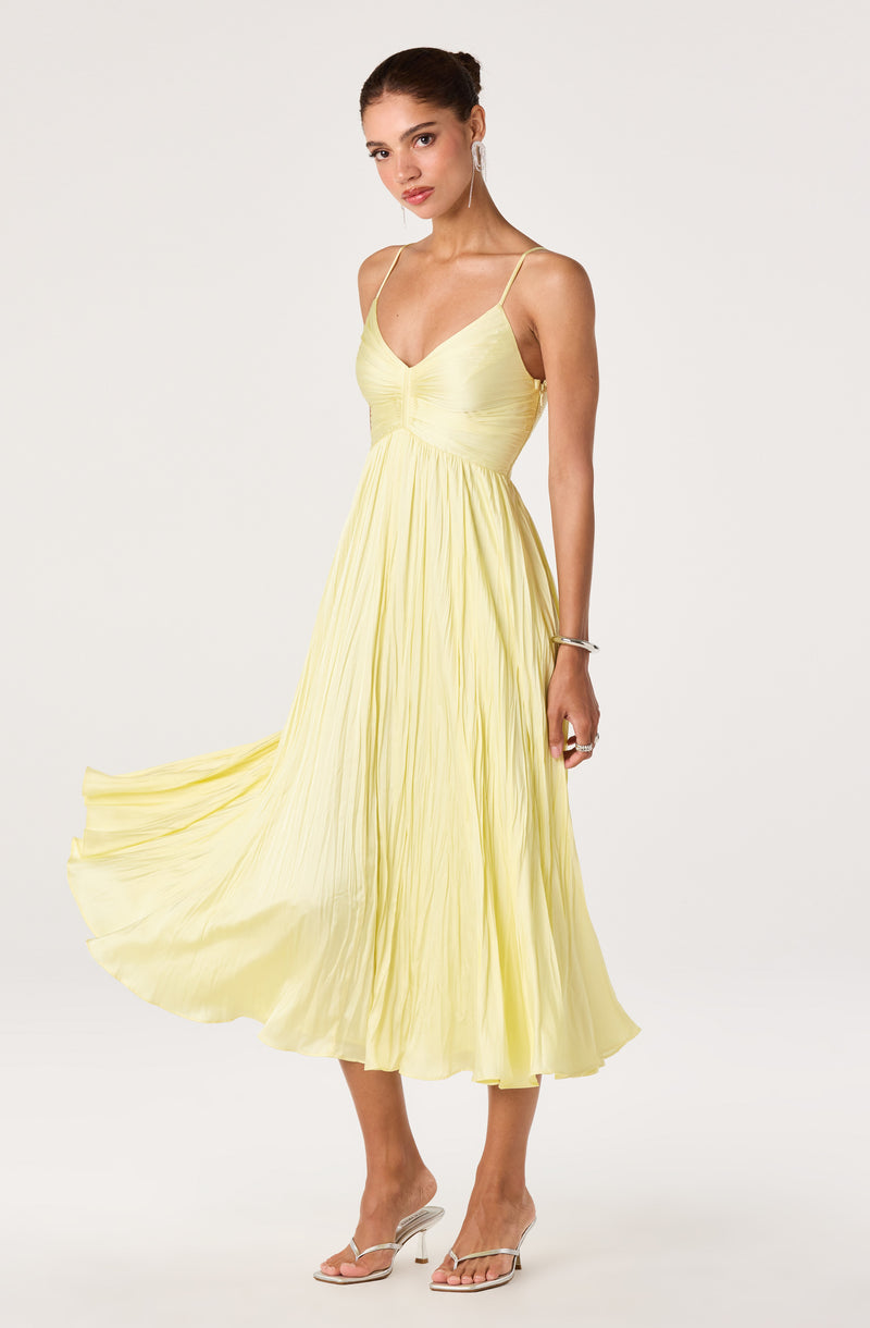 Light yellow pleated dress with thin adjustable spaghetti straps.