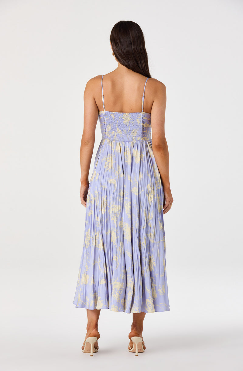 Long lavender dress with yellow floral pattern and thin shoulder straps.