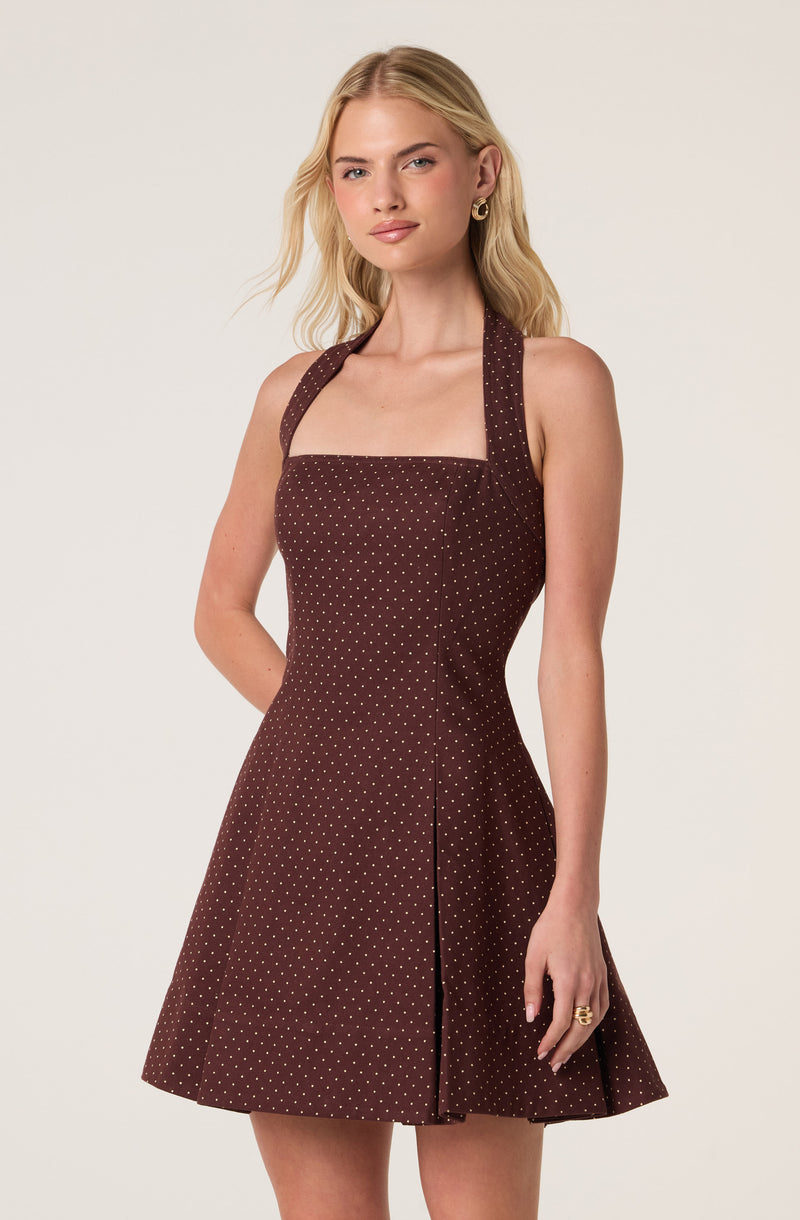 Brown dress with white polka dots, sleeveless with wide straps, fitted bodice, and flared skirt.