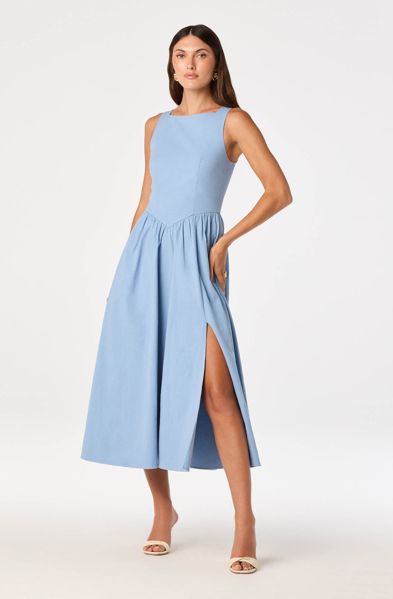 Light blue sleeveless dress with a fitted bodice and a high slit on one side.