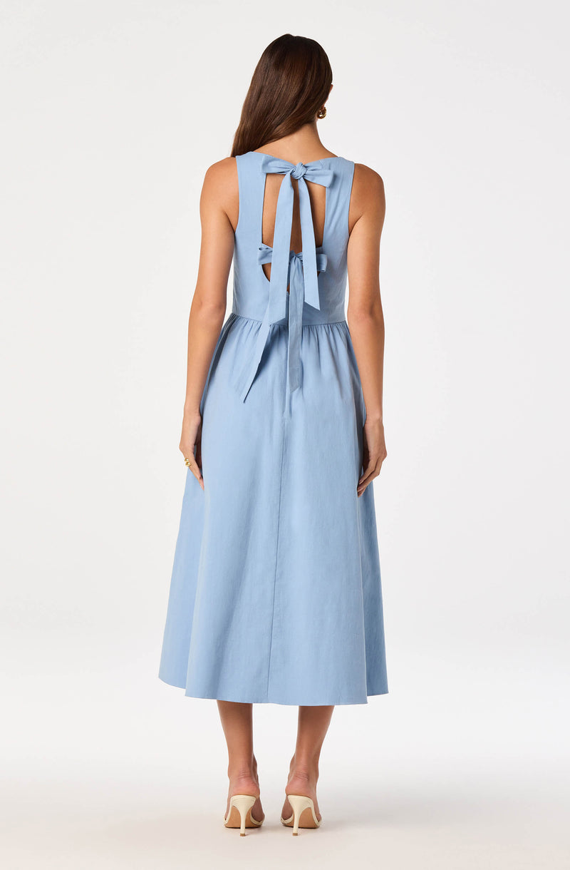 Light blue sleeveless dress with bow tie detail at back and midi length.