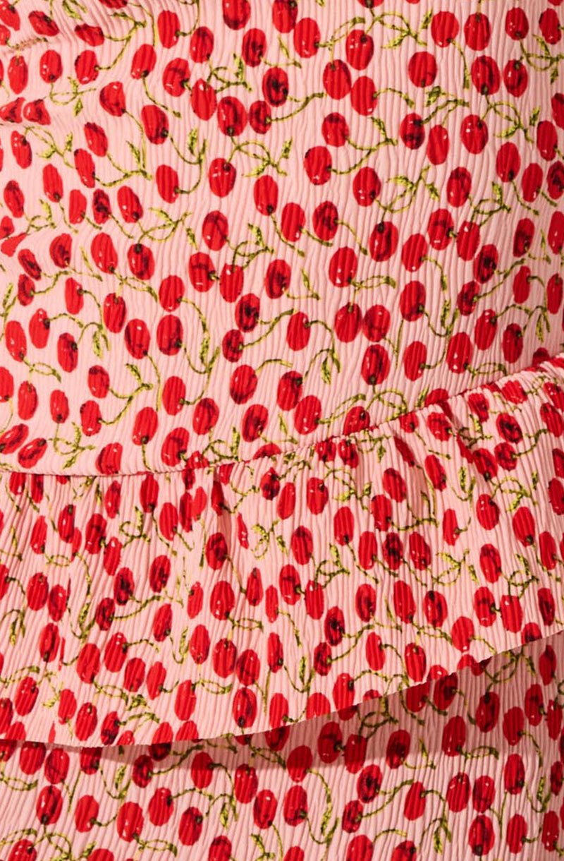 The fabric features a pattern of red cherries with green stems on a pink and white vertical striped background. The material appears to be lightweight and slightly textured.