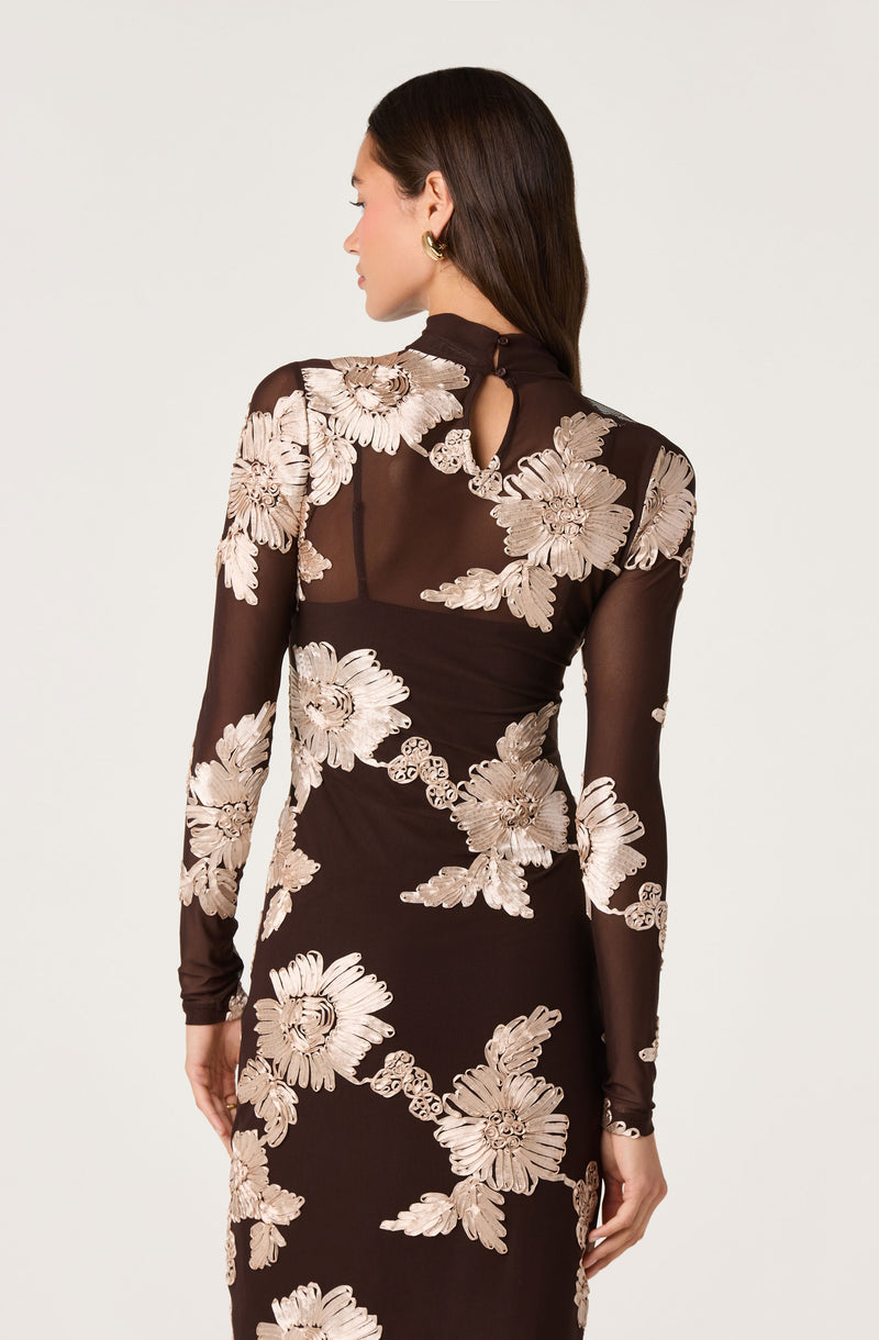 Black dress with beige floral embroidery and a keyhole back detail.