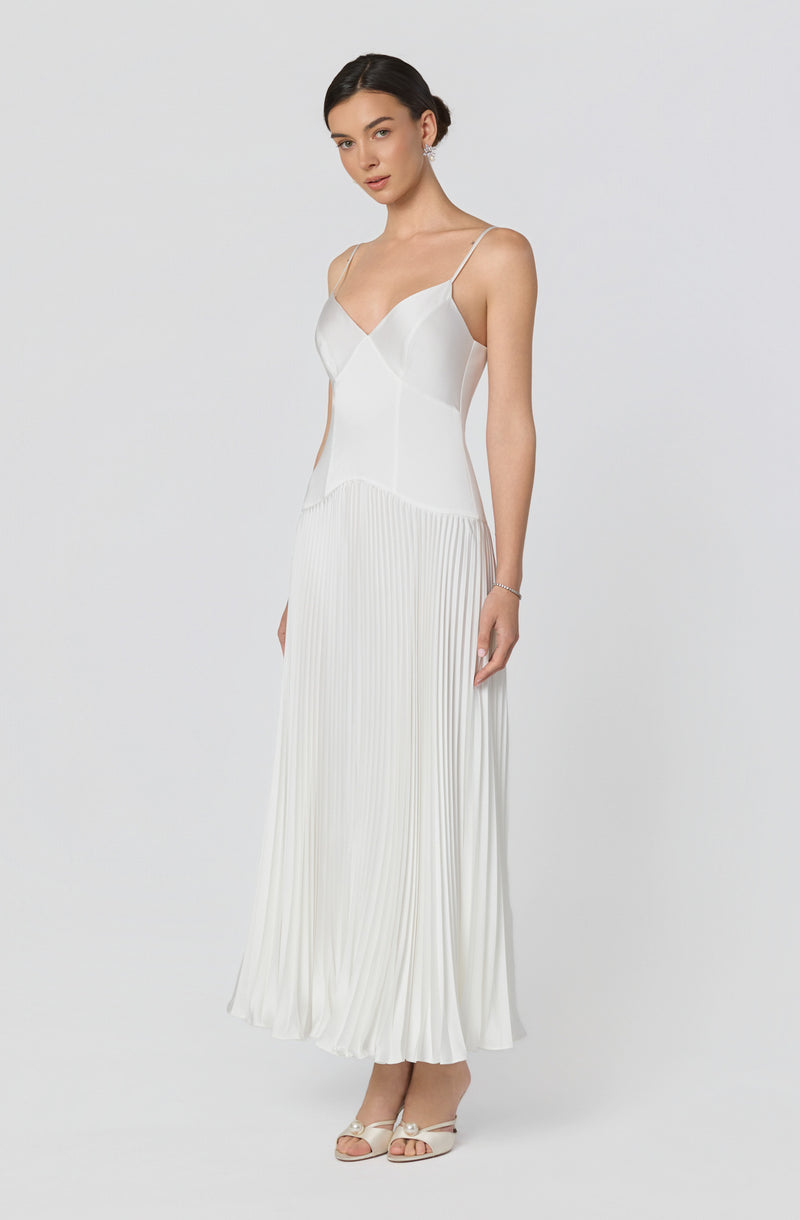 White spaghetti strap top and pleated long skirt.